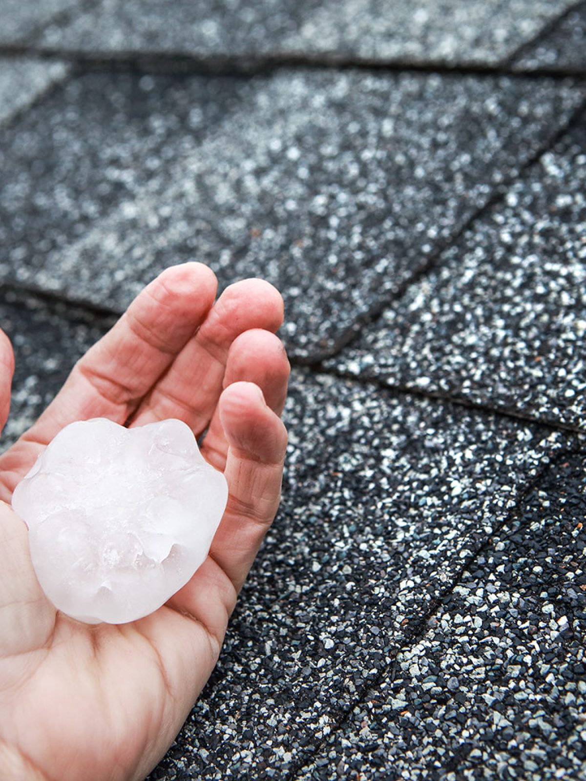 Hail in hand on a rooftop after hailstorm